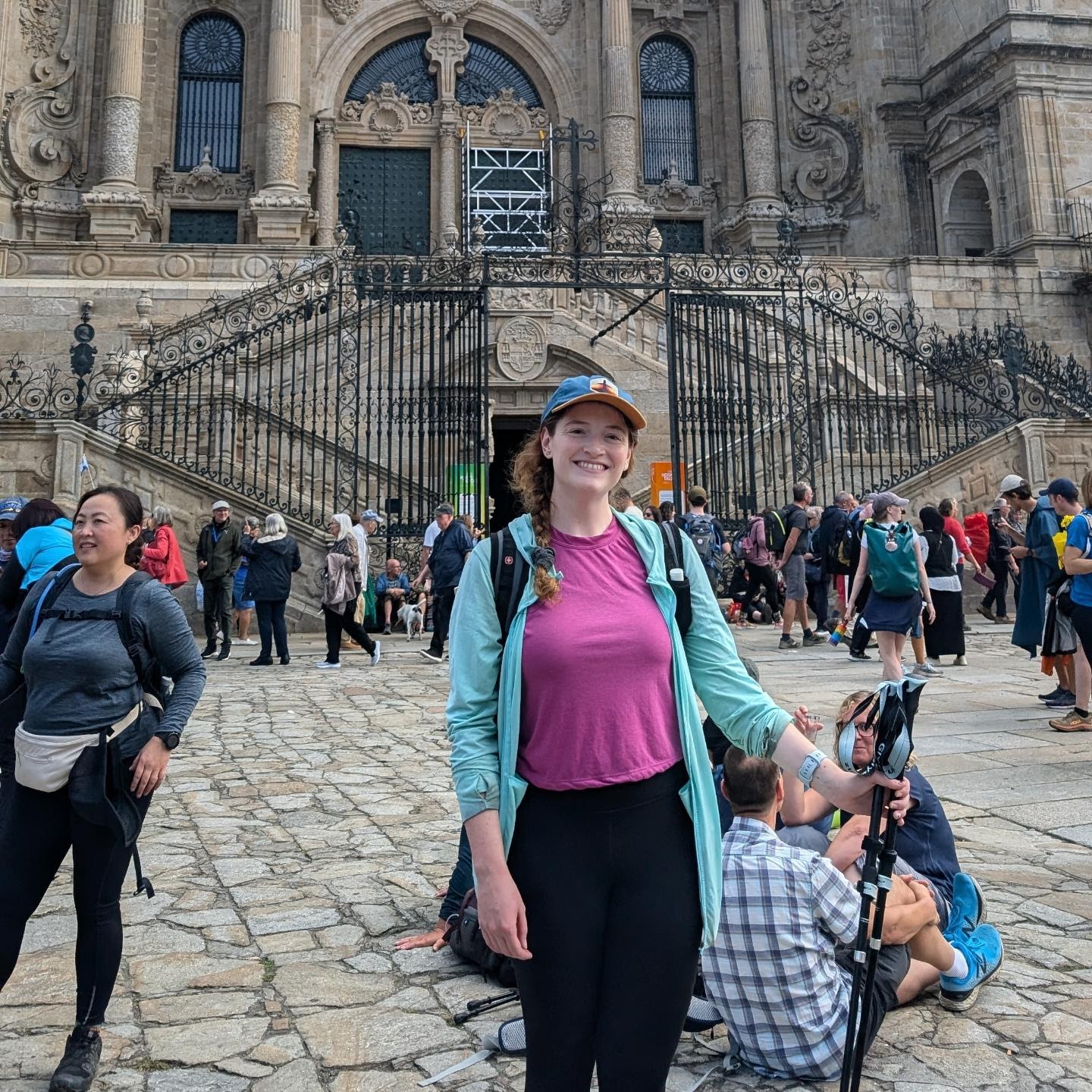 Image of Jenny with walking poles, infront of the cathedral in Santiago de Compostela