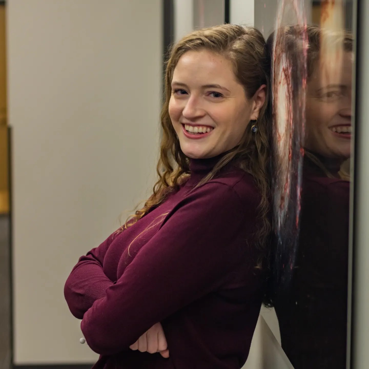 Image of Jenny crossed arms, side profile, against an image of a galaxy